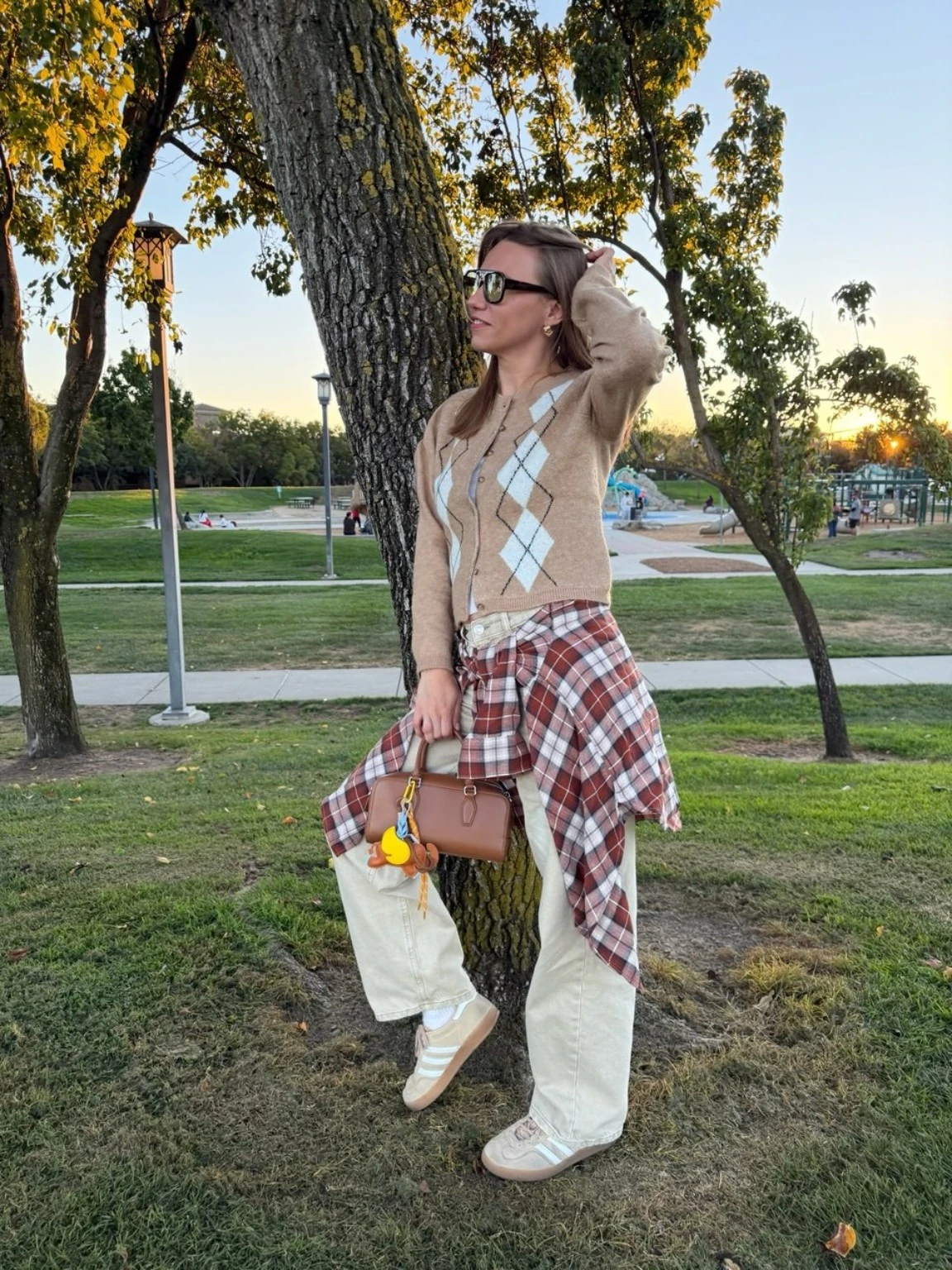 Jenny wearing a relaxed layered outfit in a park